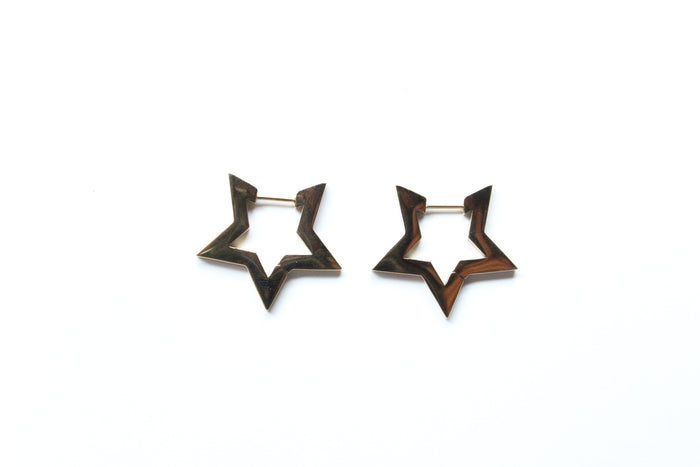 A pair of star-shaped hoop earrings with a dark brown wood-grain finish and a gold-tone metal post, displayed on a clean white background.