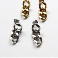 Four interlocking chain-link style earrings in polished gold and silver finishes, arranged on a clean white background.