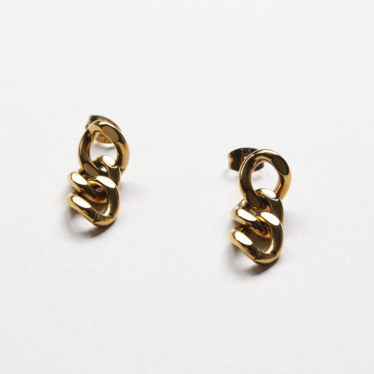 A pair of gold-toned chain-link stud earrings on a plain white background.