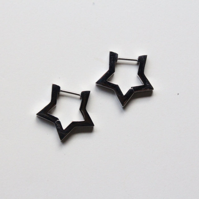 A pair of silver star-shaped hoop earrings on a plain white background.