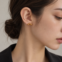 Triple ball stud earrings gold fuwa collection sensitive skin friendly. Model is natural looking like Aesope and Muji.