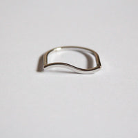 Silver ring with a wavy design on a light grey background, waterproof and hypoallergenic 