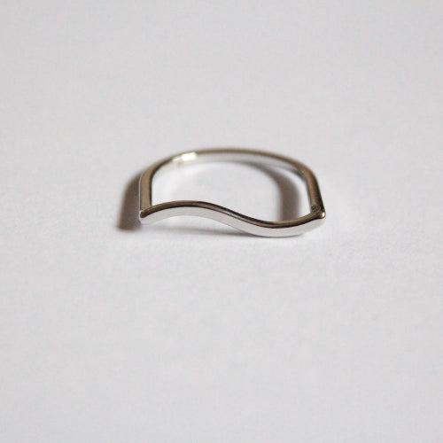Silver ring with a wavy design on a light grey background, waterproof and hypoallergenic 