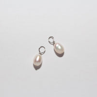 Two small freshwater pearl drop charms with silver lobster clasps, displayed on a clean white background.
