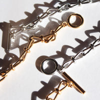 Gold and silver chain necklaces on a white background