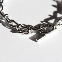 Silver chain bracelet on a white background